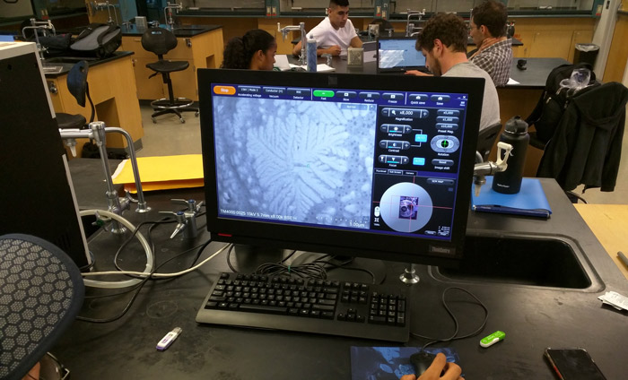 A Nanotechnology student at West Los Angeles College inspecting a crystalline sample with an Hitachi SEM.