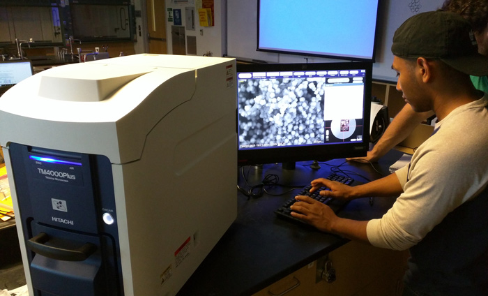 Nanotechnology students at West Los Angeles College operating an Hitachi SEM.